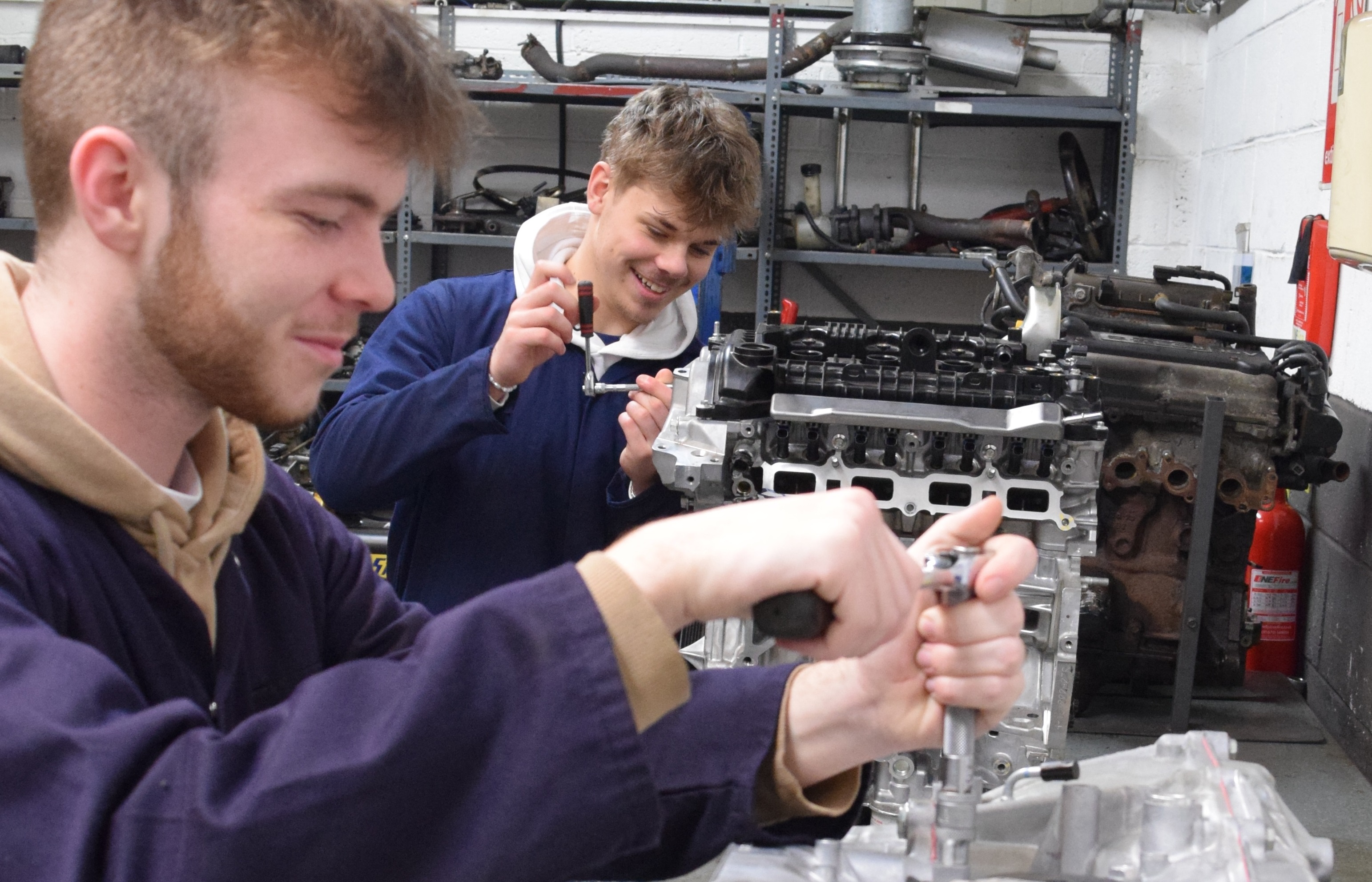 Automotive Students Working On Nissan Parts
